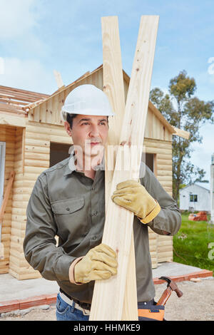 Handyman at building construction site working on DIY project Stock Photo