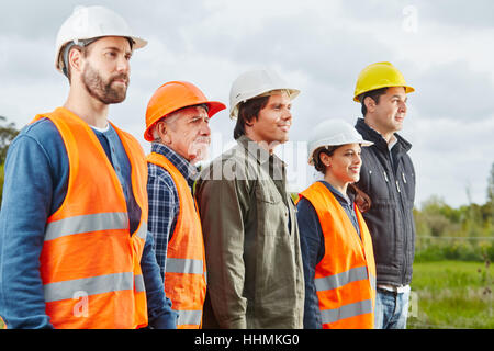 Group of construction workers standing proud and self confident Stock Photo