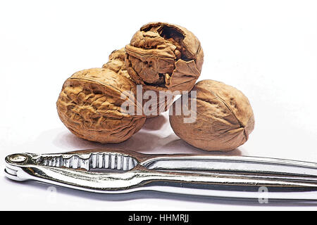 Walnuts and nutcracker on white background Stock Photo
