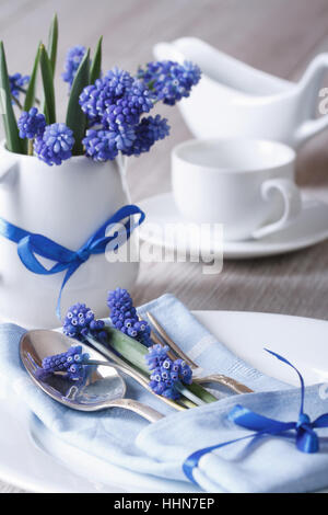 Festive table setting with blue flowers closeup. vertical Stock Photo