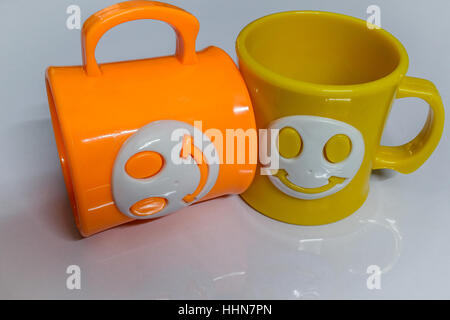 Colourful cups on a glossy white table. Stock Photo