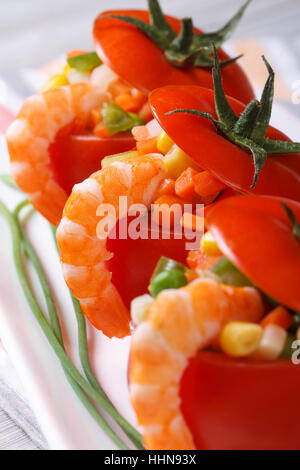 Fresh red tomatoes stuffed with vegetables and shrimp. macro. vertical Stock Photo