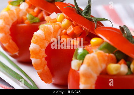 Fresh red tomatoes stuffed with vegetables and shrimp. macro. horizontal Stock Photo