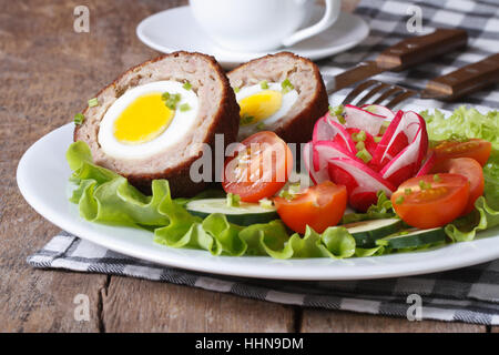 Scotch eggs with salad of fresh vegetables on a plate. horizontal Stock Photo