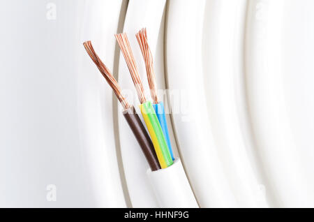 Electrical cable with three insulated conductors. Power cable cross-section. Cable jacket with wire insulation and copper wires. Stock Photo
