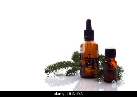 Fir essential oil in small bottles, aromatherapy setting isolated over white background.Selective focus Stock Photo