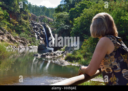 Woman tourist looking at the Mantenga Falls, in the Mantenga Nature Reserve, Eswatini, formerly Swaziland, Southern Africa Stock Photo