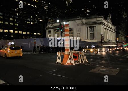 New York city steam vapor being vented through Consolidated Edison orange and white stack in middle of a junction Stock Photo