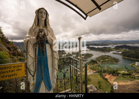 Virgin statue altar at Penon de Guatape Colombia aerial view of a residential area on the shore of the artificial lake Stock Photo