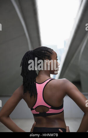 Serious Mixed Race woman wearing pink sports-bra near bridge Stock Photo -  Alamy