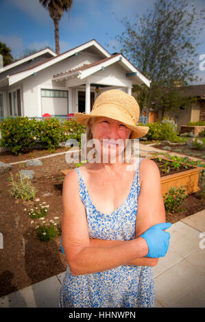 Portrait of smiling Caucasian woman posing near house Stock Photo