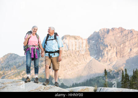 Caucasian couple hiking on mountain Stock Photo
