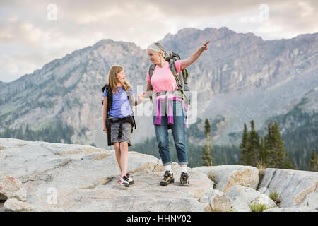 Caucasian grandmother and granddaughter hiking on mountain Stock Photo