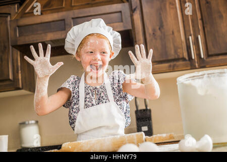 Caucasian girl covered in flour Stock Photo