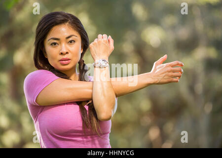 Portrait of Asian woman stretching arms Stock Photo