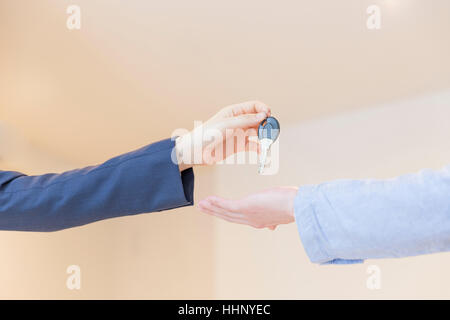 Woman Handing Key over to A Man Stock Photo