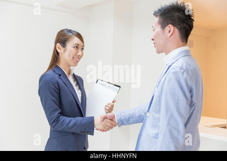 Real Estate Agent Shaking Hands with Buyer Stock Photo