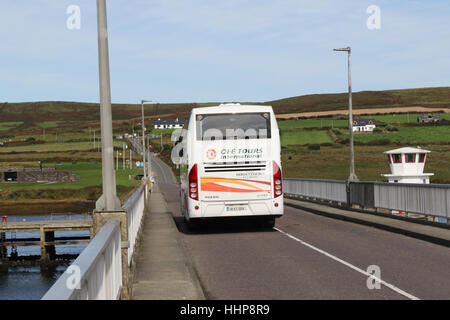 The road bridge between Valentia Island and Portmagee, County Kerry, Ireland. The coach is travelling to Valentia Island. Stock Photo