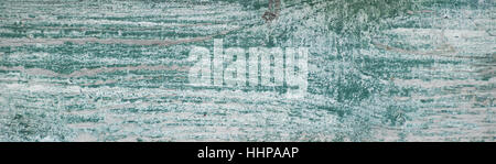 Worn white weathered painted board with green underneath Stock Photo