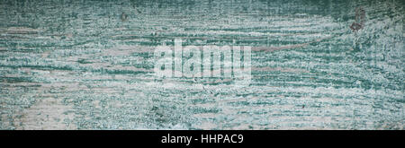 Worn white weathered painted plank with green underneath Stock Photo