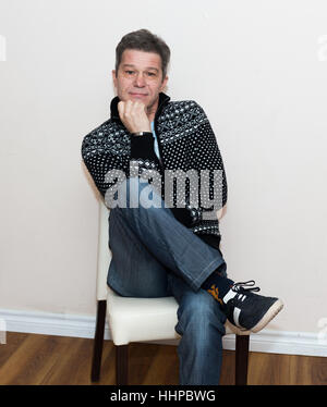 Portrait of a young man sitting and thinking. Stock Photo