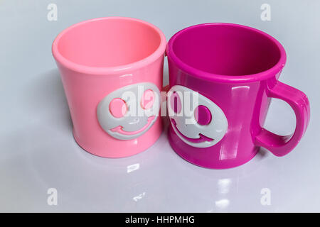 Colourful cups on a glossy white table. Stock Photo