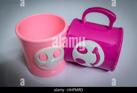 Colourful cups on a glossy white table. Stock Photo