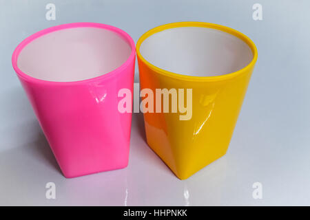 Colourful cups on a glossy white table. Stock Photo