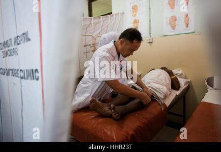 (170120) -- BEIJING, Jan. 20, 2017 (Xinhua) -- A doctor of China's medical aid team operates acupuncture threament on a local patient in Tanzania's Zanziba, July 15, 2016. Chinese President Xi Jinping presented a bronze acupuncture statue on Jan. 18, 2017 to the World Health Organization (WHO) in Geneva, Switzerland, which shows acupuncture points on the human body. According to the WHO, 103 members have given approval to the practice of acupuncture and moxibustion, with 29 having enacted special statutes on traditional medicine, and 18 having included acupuncture and moxibustion treatment in Stock Photo