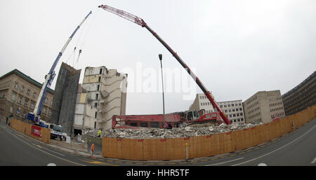 Berlin-Mitte, Germany. 20th Jan, 2017. An excavator and two cranes can be seen on a site at Wilhelmstrasse 56 - 59 in Berlin-Mitte, Germany, 20 January 2017. In the past months, former prefabricated-slab ('Plattenbau') buildings have been demolished here. Only a small remainder of the residential building still stands. After the demolition, work on the site between Behren and Franzoesischer Strasse will see the construction of new residential building with more than 100 luxury apartments. Photo: Paul Zinken/dpa/Alamy Live News Stock Photo