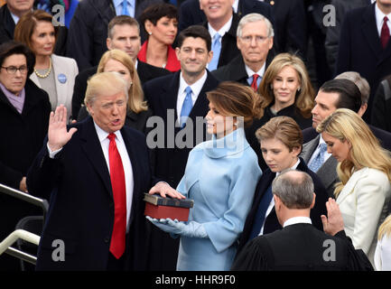 Washington, USA. 20th Jan, 2017. U.S. President Donald Trump(L) takes the oath of office during the presidential inauguration ceremony at the U.S. Capitol in Washington, DC, the United States, on Jan. 20, 2017. Donald Trump was sworn in on Friday as the 45th President of the United States. Credit: Yin Bogu/Xinhua/Alamy Live News Stock Photo