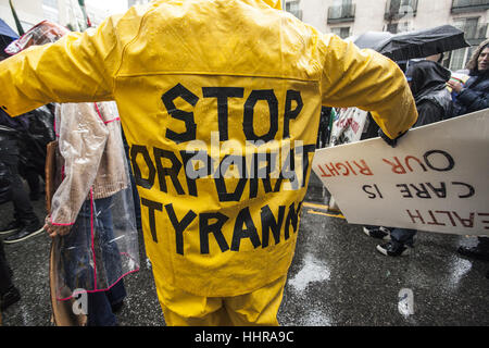 Los Angeles, California, USA. 20th Jan, 2017. Downtown Los Angeles, California. In spite of the downpour of rain protesters turn out to march against the Presidency of Donald Trump. Stop Corporate Tyranny. Credit: Dave Banks/ZUMA Wire/Alamy Live News Stock Photo