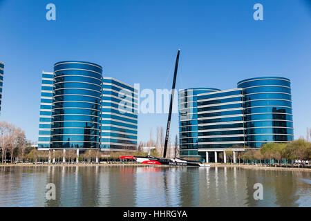 Oracle Corporation headquarters / buildings with a Oracle Team USA yacht racing boat in a pool at Redwood Shores, California Stock Photo