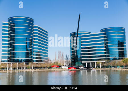 Oracle Corporation headquarters / buildings with a Oracle Team USA yacht racing boat in a pool at Redwood Shores, California Stock Photo