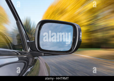 Driving along a country road at sunny fall day Stock Photo