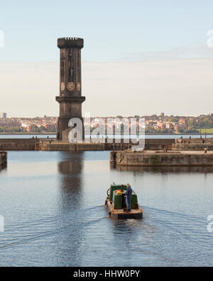 A barge leaves Salisbury Dock overlooked by the Gothic Victoria Tower, a Grade II listed Gothic Revival clock tower, Liverpool Stock Photo