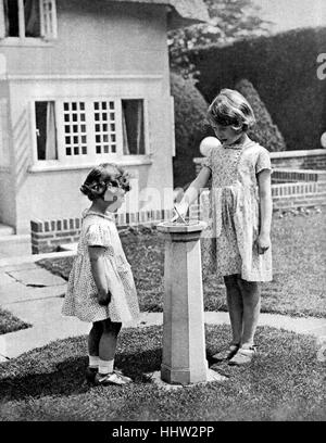 Princess Elizabeth (to become Queen Elizabeth II) and Princess Margaret as children in the 'grounds' of the model house - Y Stock Photo