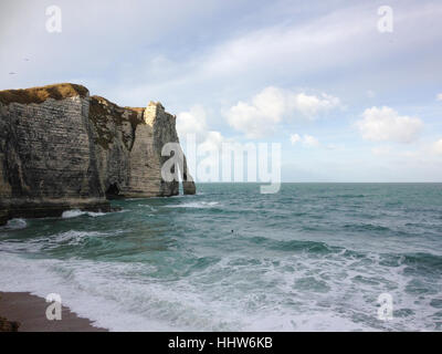 View on Falaise d'Etretat with surfer in the water Stock Photo