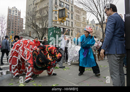 Chinese dragon dancers perform in order to bring good fortune to a new Chinese restaurant on 4th Ave. in Greenwich Village, NYC. Stock Photo