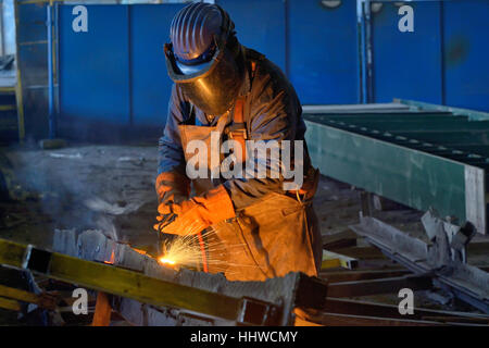 Welder welding metal in plant Stock Photo