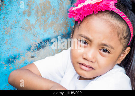 Small girl in slum by Bangkerohan River, Davao, Davao Del Sur, Philippines Stock Photo