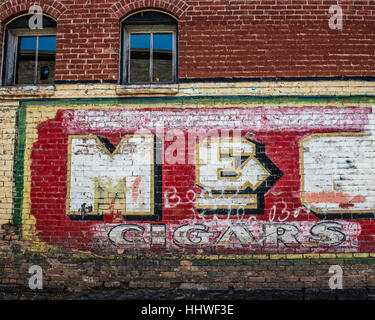 The M&O faded Cigar mural in a Glenwood Springs alley. Glenwood Springs. Colorado. USA Stock Photo