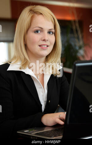 Business woman with laptop in a coffeehouse Stock Photo
