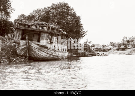 Black and white photo add texture vintage style of the old damaged wooden boat beached on the waterfront for background in Phra Nakhon Si Ayutthaya Stock Photo