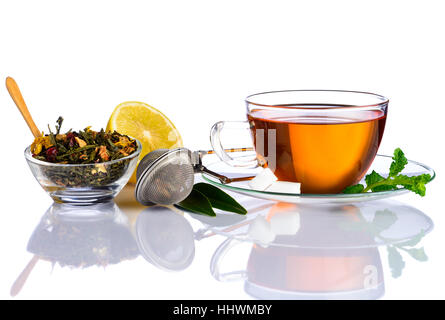 Tea Cup with Tea ingredients, dried herbs and sliced Lemon on white background Stock Photo