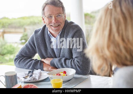 Senior couple eating breakfast on patio Stock Photo