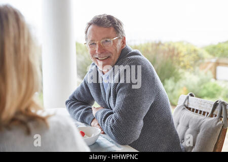 Senior couple talking on patio Stock Photo