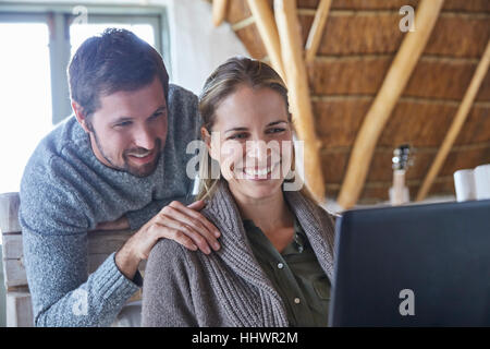 Smiling couple using laptop Stock Photo