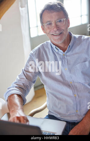 Portrait smiling senior man using laptop Stock Photo
