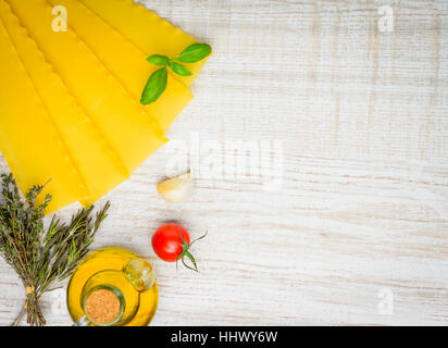 Yellow Reginette Lasagna Pasta and Rosemary with thyme herbs and Olive oil Seasoning with copy space Stock Photo
